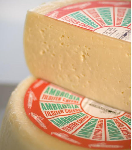 Ambrosia. The cheese's interior is pale yellow with small irregular holes. It is aged for a minimum of two months and is then encased in a yellow wax which helps maintain the cheese’s moisture and creaminess. It has an open, springy texture and a mellow, buttery flavour that is popular with cheese lovers of all ages.