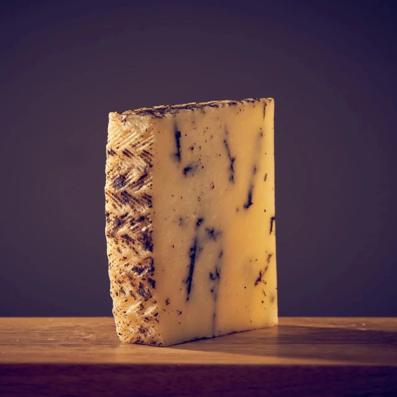 Brebitruffe Tradition. A rich, pungent truffle aroma wafts out of the cheese as soon as you cut into the dense but pliant curd. Pale butter yellow in appearance, the black streaks of truffle stand out where they have settled into natural crevices throughout the wheel. The bold and earthy flavour of the truffle complements the characteristically buttery flavour of the cheese.