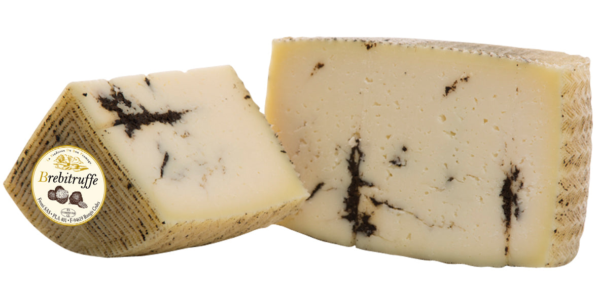 A rich, pungent truffle aroma wafts out of the cheese as soon as you cut into the dense but pliant curd. Pale butter yellow in appearance, the black streaks of truffle stand out where they have settled into natural crevices throughout the wheel. The bold and earthy flavour of the truffle complements the characteristically buttery flavour of the cheese.