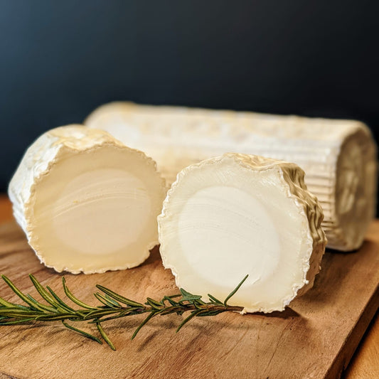 There is a white velvety mould on the rind and a dry, slightly firm centre. As this cheese ripens, it becomes soft and creamy underneath the rind, while the centre remains slightly firm. The flavour is tangy and herbaceous with lovely citrus overtones. As this cheese matures, it deepens in pungency and flavour.