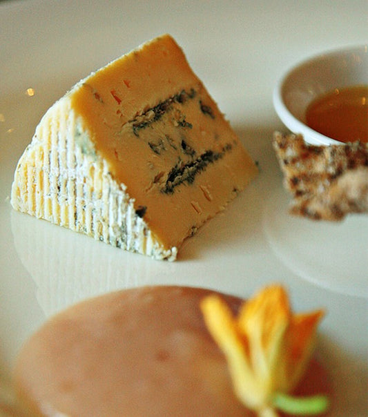 This blue cheese gets its distinctive colour from the addition of annatto, a food colouring derived from the seeds of the achiote tree, which has been used in cheesemaking for centuries. The veining is even throughout and the texture is creamy. There is a lovely sweetness in the cheese with a gentle spiciness from the blue. A very approachable blue vein for beginners.