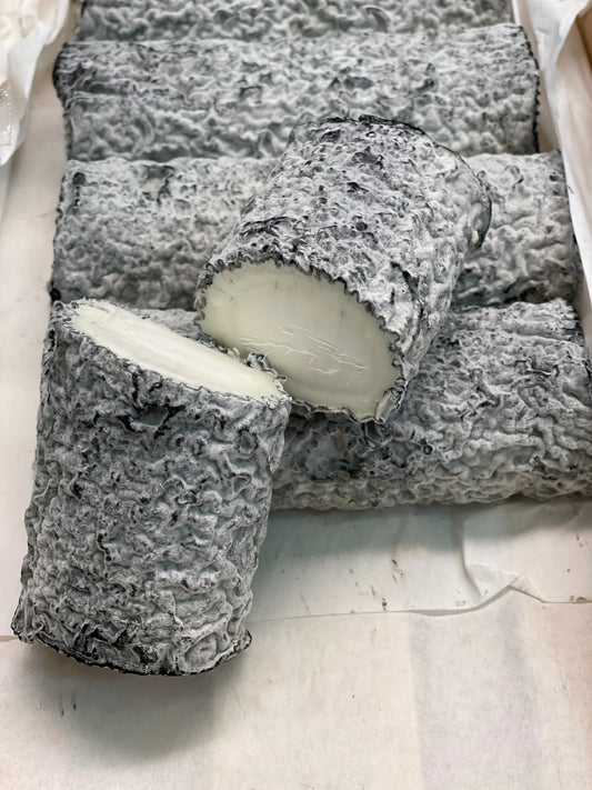 The rind is dusted with salt and wood ash which provides a lovely contrast to the pure white interior of the cheese. The centre remains chalky as the cheese softens elegantly under the increasingly wrinkly rind.