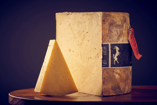 This 25kg wheel is handmade using traditional techniques. The cheese is cloth wrapped in muslin, allowing it to breathe and develop character while also forming the rind that is typical for traditional cheddar. This classic cheese has a tremendous, crumbly yet creamy texture and an earthy flavour with a lingering finish.