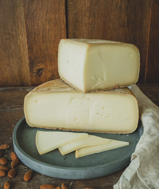 These gorgeous wheels are matured for a minimum of 60 days by which time they have developed a natural grey-orange rind. The interior is pale off-white with a soft texture and a velvety, buttery mouthfeel.  The combination of goat and sheep milk creates a harmonious balance of an initial herbaceous and nutty flavour, followed by a sweet, gentle finish.