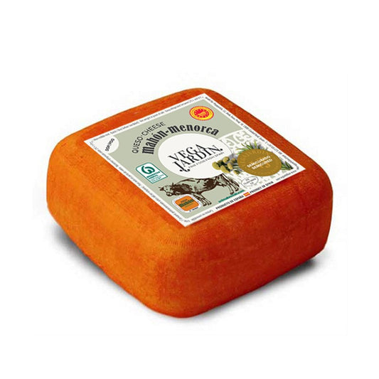 Mahón is pressed and twisted for a number of days giving the cheese its typical "cushion" shape.  The hard rind, which carries the imprint of the cheesecloth, is rubbed with oil and paprika creating a vibrant orange colour.  Mahón is sold at various stages of maturity. When young, the texture is smooth and supple and the aroma is sweet and fruity. It can be matured for up to ten months when it will exhibit a hard, slightly granular texture with a sharp, salty tang.