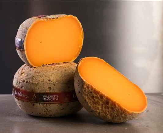 Flattened top and bottom, and about the size of a small bowling ball, it begins its life as Mimolette Jeune. After maturation the centre acquires a perfumed yet salty flavour and graduates to be called Mimolette Vieille.