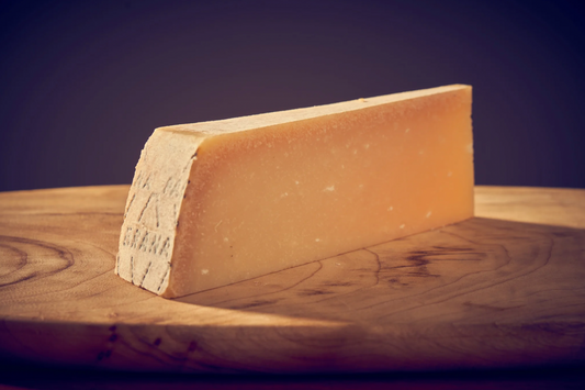 The large wheels are slightly convex in shape with an oily, golden rind. This rind encases a hard but crumbly interior that is white to straw yellow in colour. The result is a fine grained texture and fragrantly fruity flavour when young which develops a sweeter, stronger flavour with age.