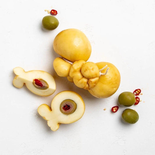 The provolina shaped smoked cheese has a centre of green olive filled with fiery red chilli. The stuffed olive is inserted into the stretched curd before it is tied in a knot at the top, giving its characteristic shape and special spicy flavour. This is then lightly smoked.