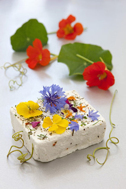 This gorgeous cheese is made using beautiful fresh chèvre, which is first coated in a selection of special herbs to season the cheese. The finishing touch is a selection of edible organic flowers. The result is a work of art which lives up to its name.