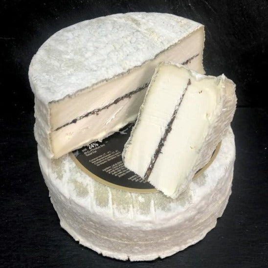 The Jacquin family are third generation cheese makers in the Loire where they make chèvre from both raw and pasteurised milk.  Tomme Adrienne is a soft pasteurised goat milk cheese with a thin layer of summer truffles and lightly coated with ash. 